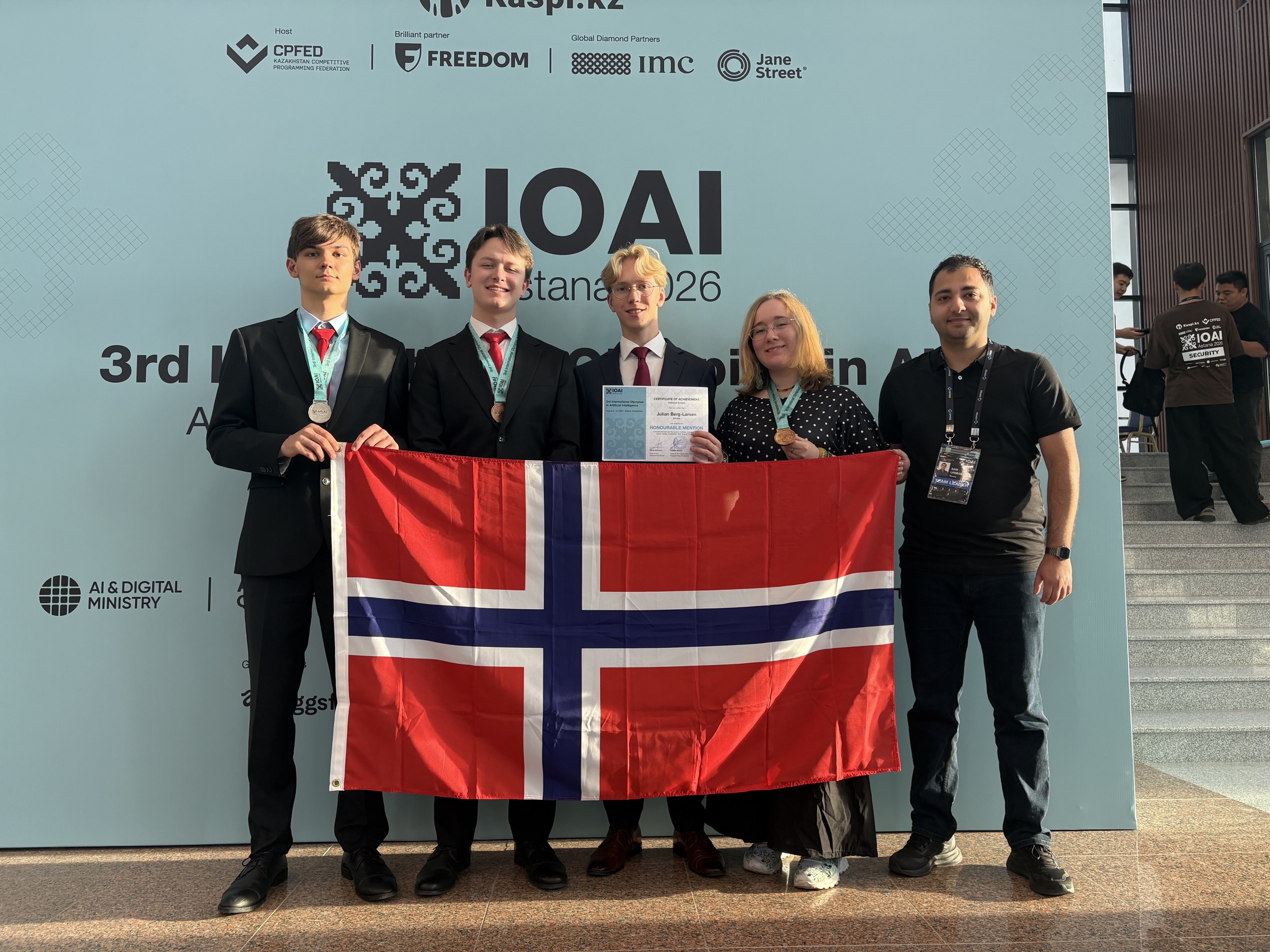 The Norwegian IOAI 2026 team with the Norwegian flag in Astana